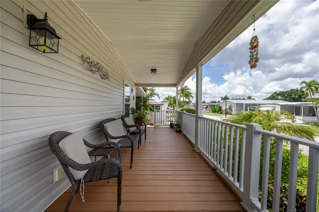 a view of a chairs and table in patio with wooden fence