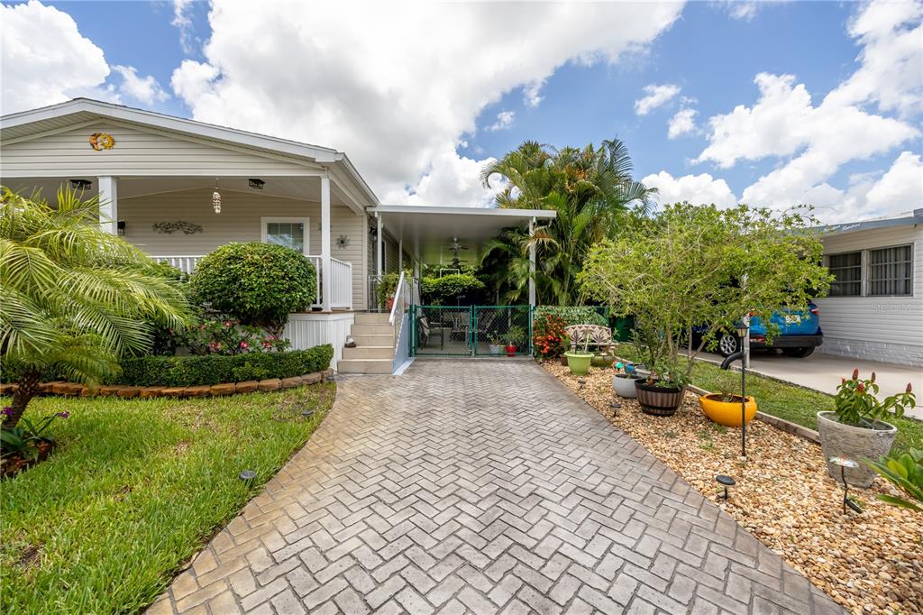 1890 Southwest 83rd Terrace Davie, FL 33324 - Photo 33 of 46 a view of a house with backyard sitting area and garden