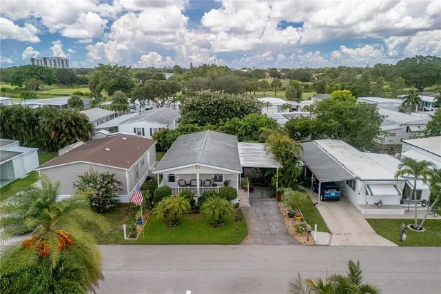 an aerial view of multiple houses with a yard