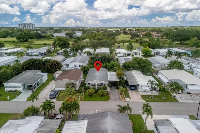 an aerial view of a houses with a lot of trees