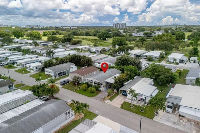 an aerial view of a houses with a yard