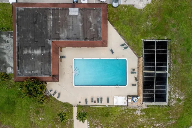 an aerial view of residential houses with outdoor space and swimming pool