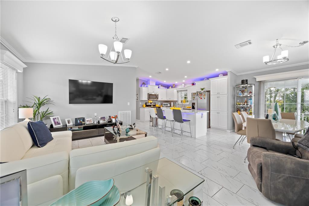 1890 Southwest 83rd Terrace Davie, FL 33324 - Photo 5 of 46 a living room with furniture kitchen view and a flat screen tv