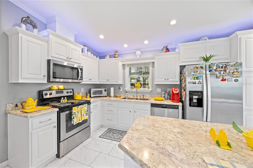 1890 Southwest 83rd Terrace Davie, FL 33324 - Photo 8 of 46 a kitchen with granite countertop a refrigerator stove top oven and sink
