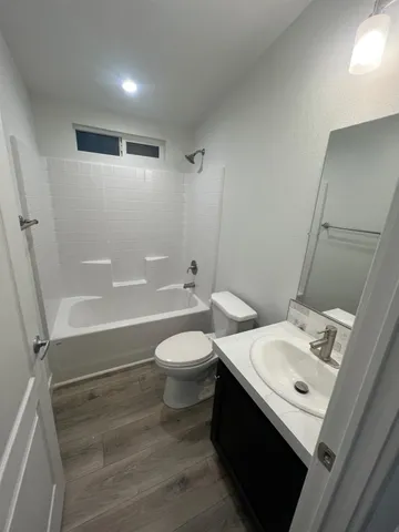 a spacious bathroom with a double vanity sink and a mirror