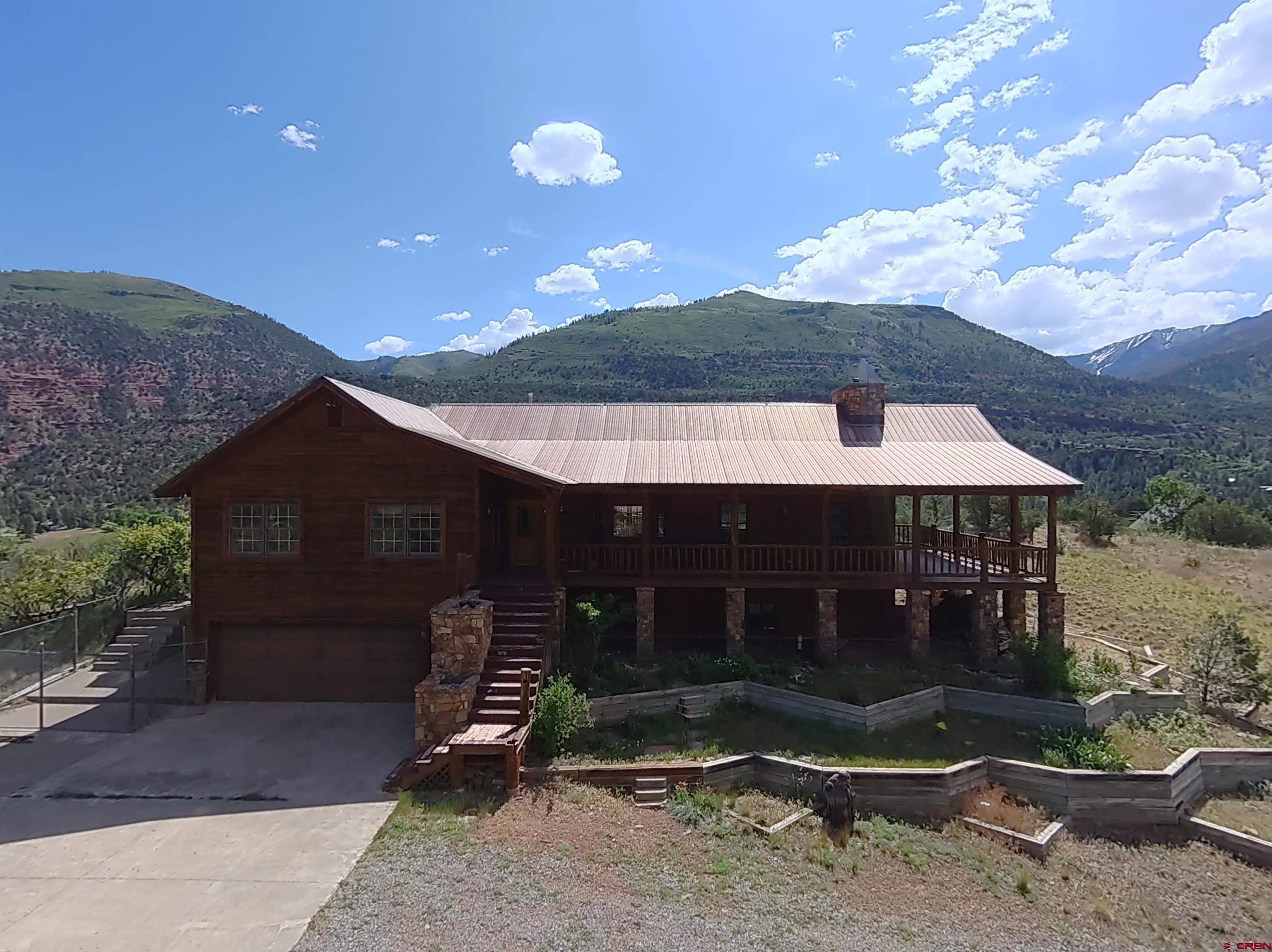 2692 County Road 17 Ridgway, CO 81432 - Photo 3 of 38 a backyard of a house with barbeque oven fire pit table and chairs