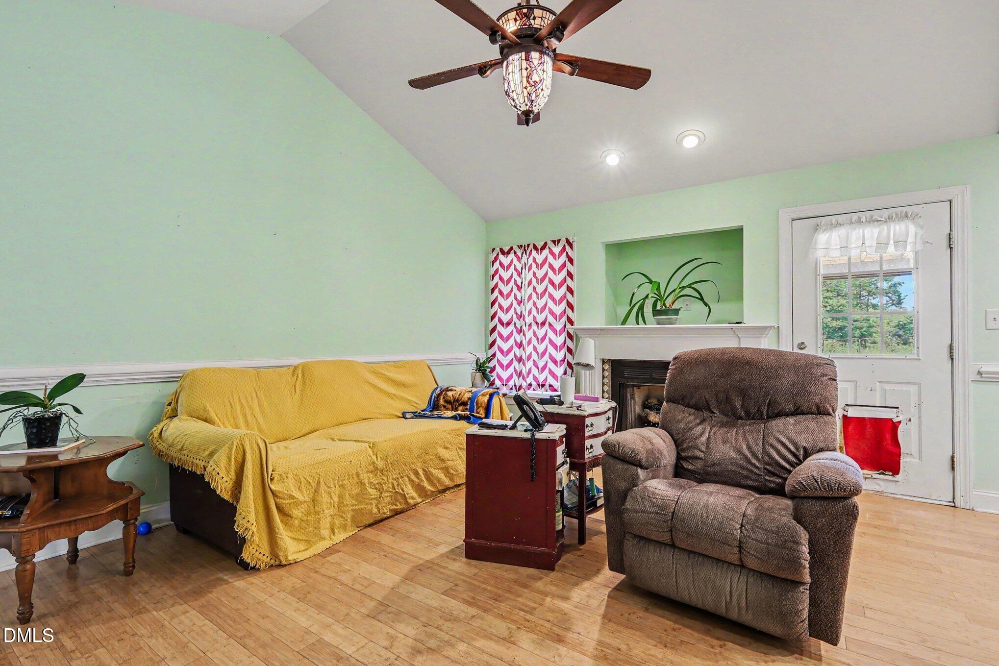 1750 Tom Oakley Road Timberlake, NC 27583 - Photo 6 of 31 a living room with furniture and a window