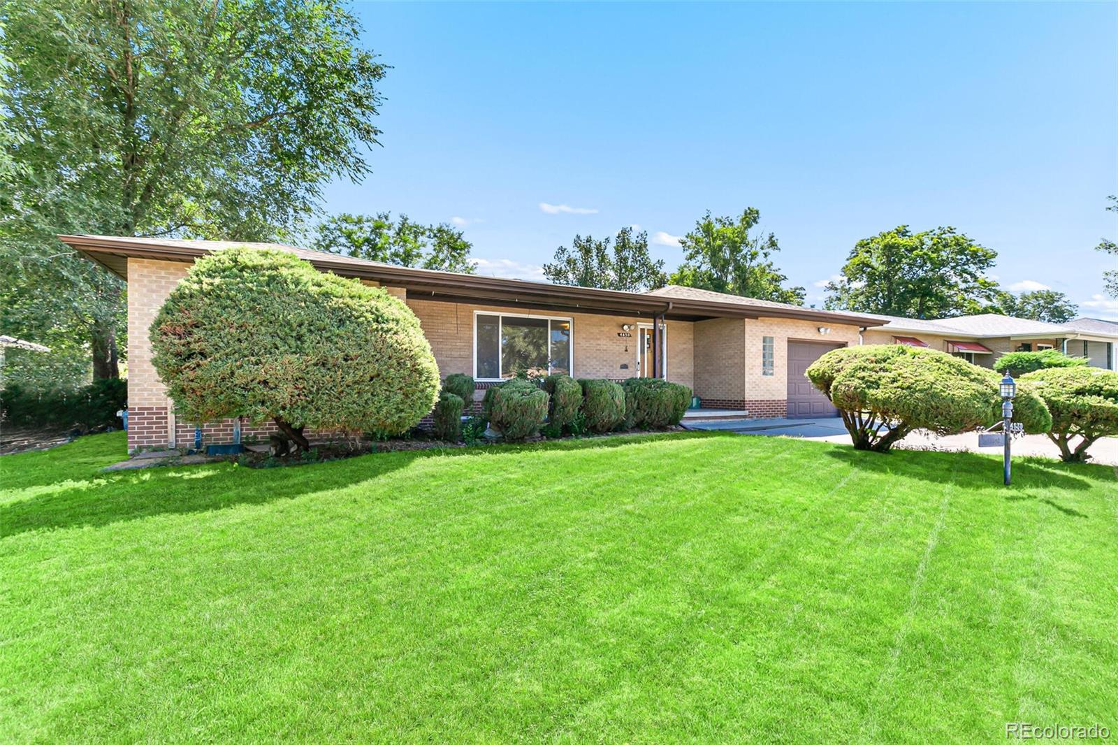 4650 Reed Street Wheat Ridge, CO 80033 - Photo 1 of 40 a view of a house with backyard and garden