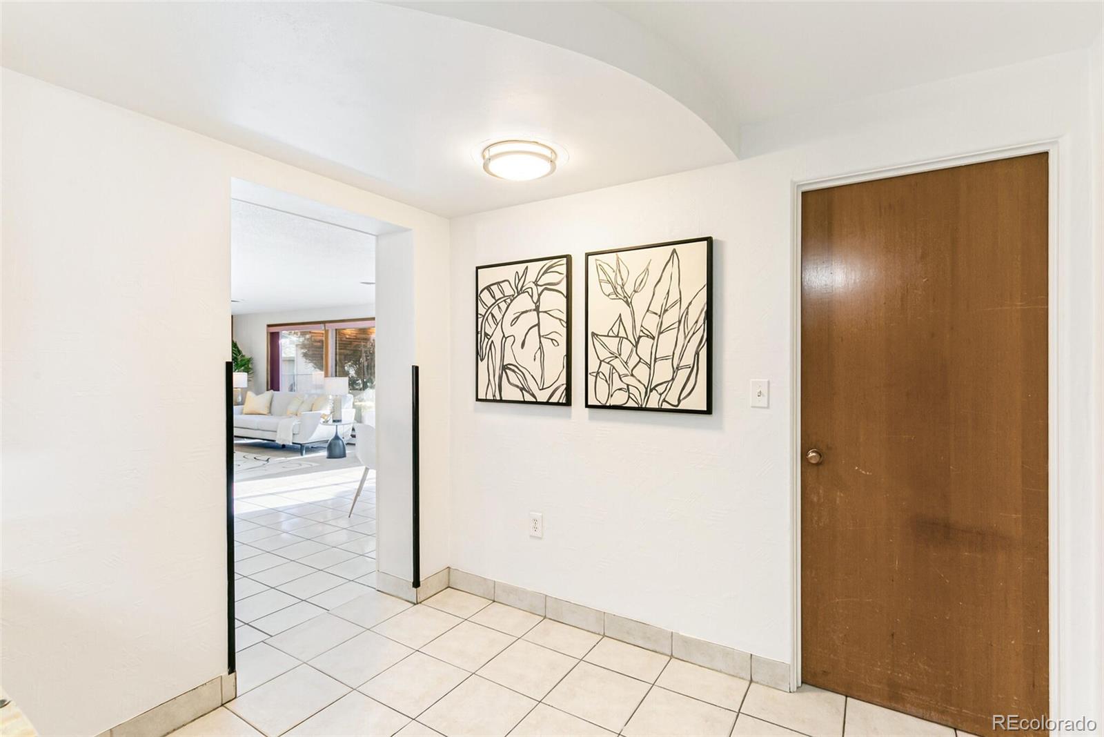 4650 Reed Street Wheat Ridge, CO 80033 - Photo 14 of 40 a view of a hallway to rooms and wooden floor
