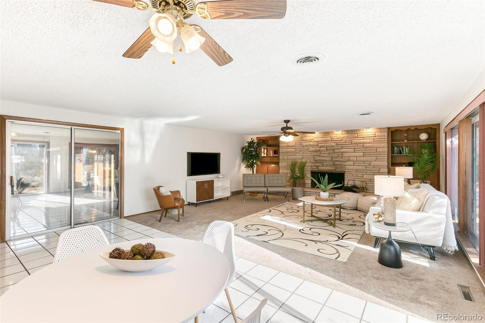 4650 Reed Street Wheat Ridge, CO 80033 - Photo 15 of 40 a living room with fireplace furniture and a floor to ceiling window