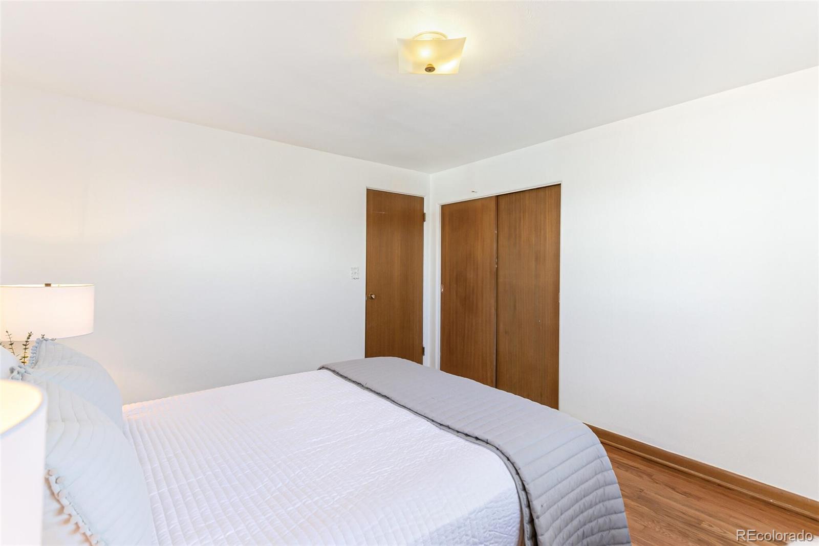 4650 Reed Street Wheat Ridge, CO 80033 - Photo 26 of 40 a bedroom with a bed and a table