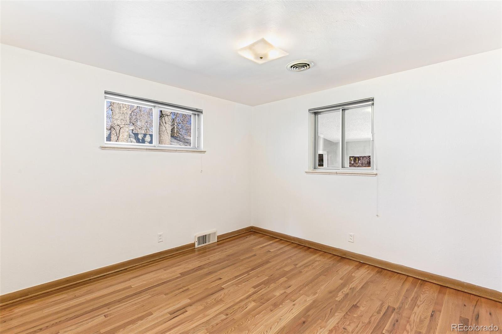 4650 Reed Street Wheat Ridge, CO 80033 - Photo 28 of 40 a view of empty room with wooden floor