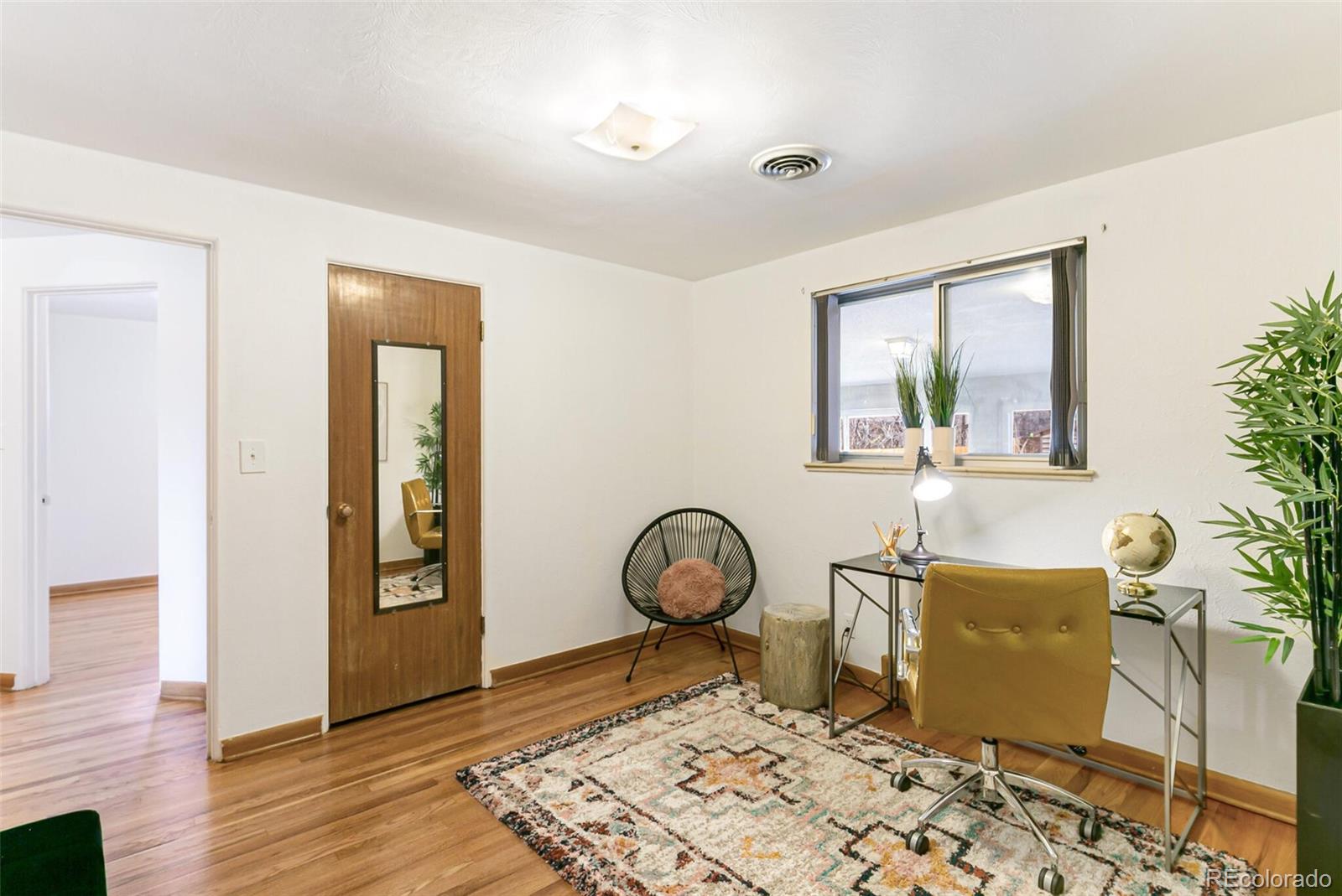4650 Reed Street Wheat Ridge, CO 80033 - Photo 30 of 40 a room with furniture and wooden floor