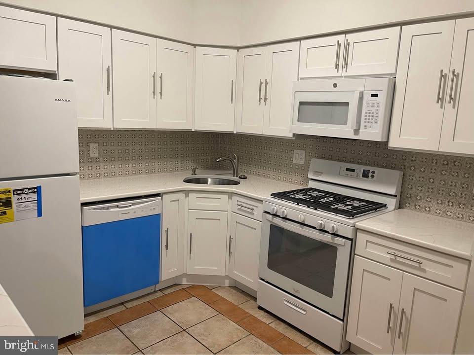 301 Byberry Road, Unit F7 Philadelphia, PA 19116 - Photo 11 of 19 a kitchen with white cabinets and white appliances