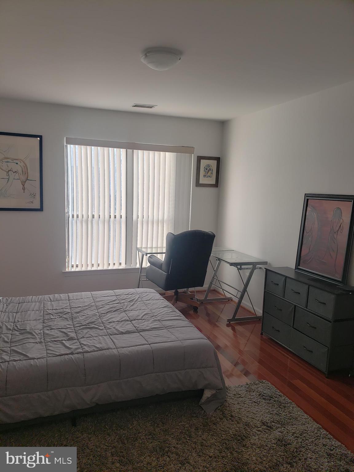 301 Byberry Road, Unit F7 Philadelphia, PA 19116 - Photo 16 of 19 a bedroom with a bed a window and dresser