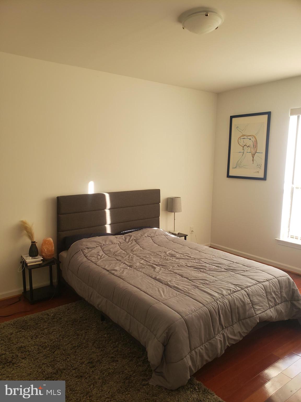 301 Byberry Road, Unit F7 Philadelphia, PA 19116 - Photo 17 of 19 a bedroom with a bed and wooden floor