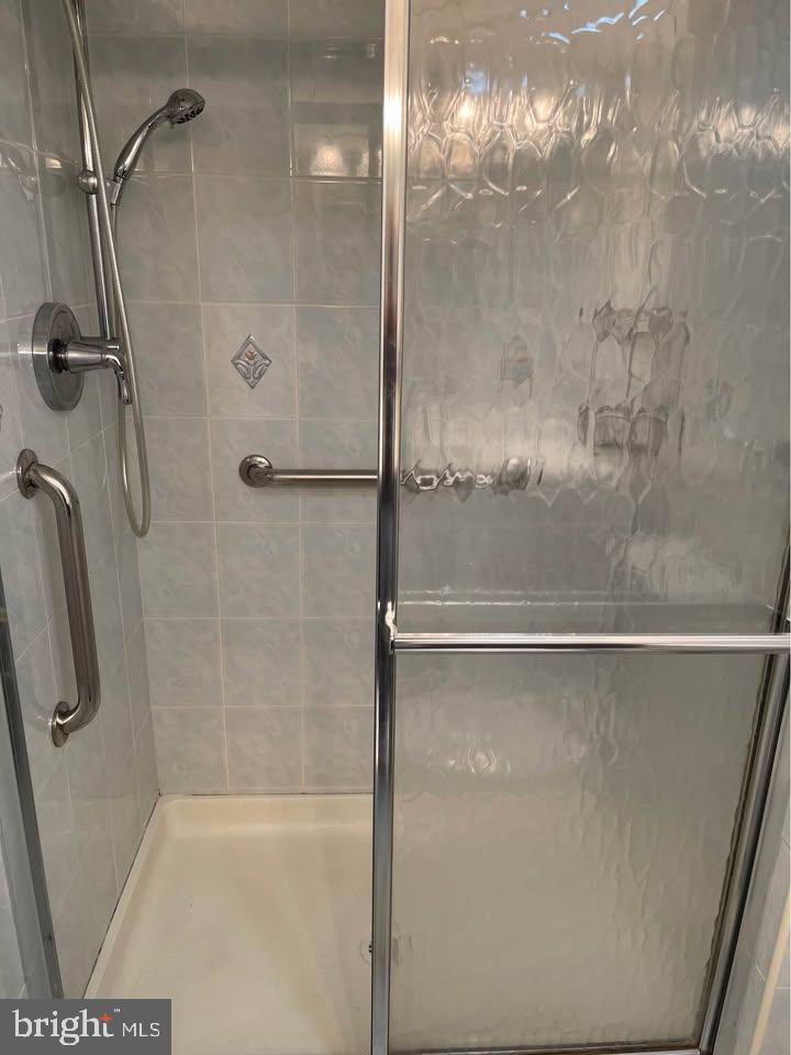301 Byberry Road, Unit F7 Philadelphia, PA 19116 - Photo 19 of 19 a bathroom with a glass shower door