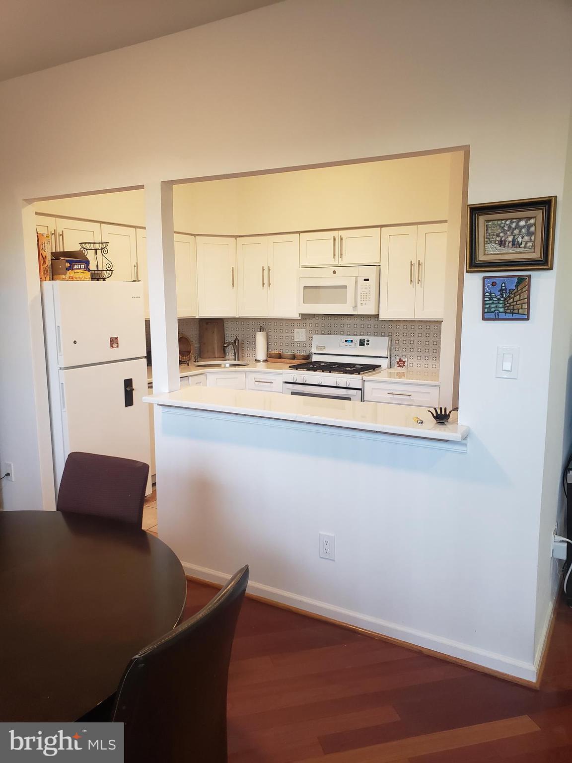 301 Byberry Road, Unit F7 Philadelphia, PA 19116 - Photo 9 of 19 a kitchen with stainless steel appliances a refrigerator and a cabinets