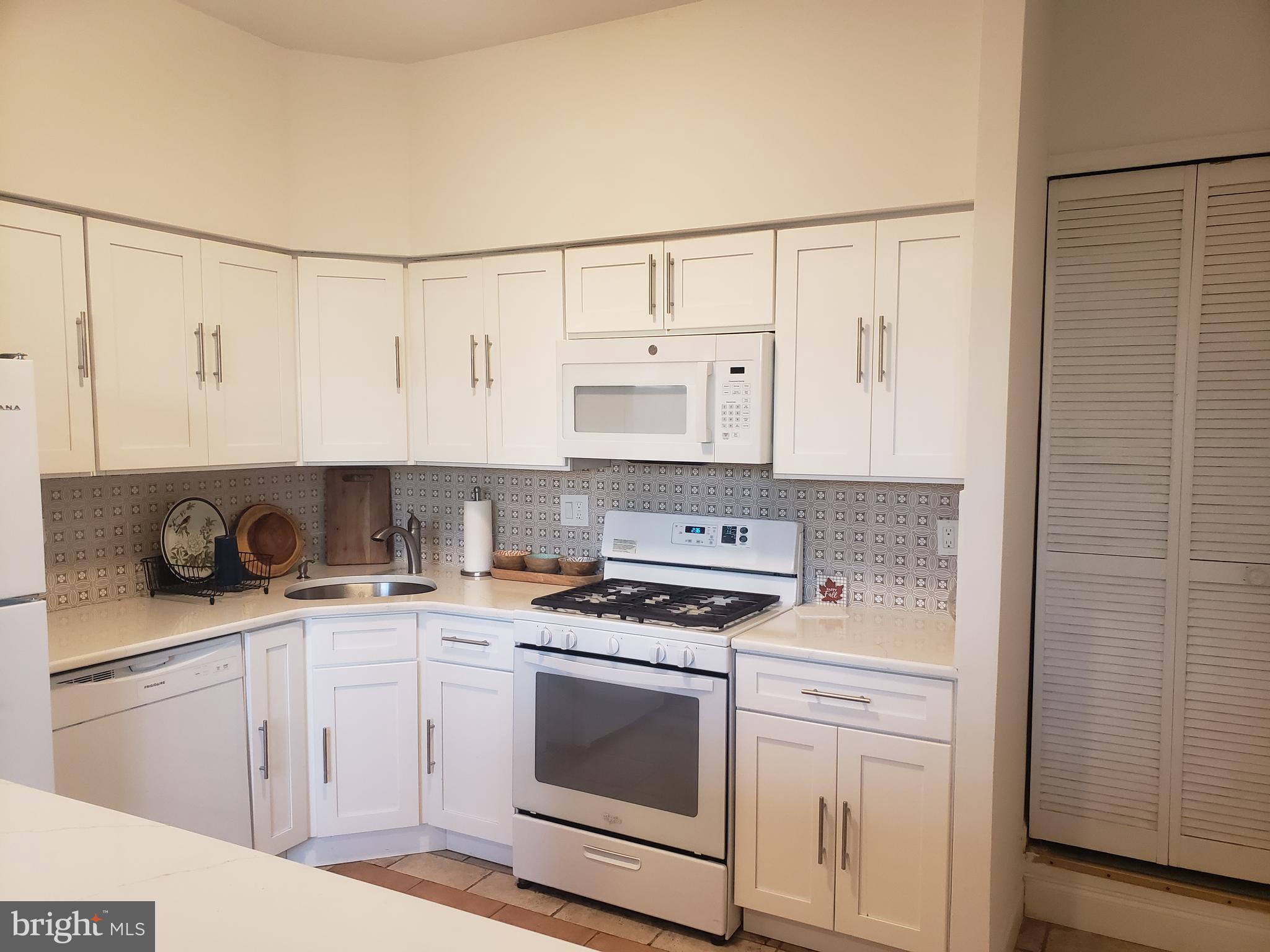 301 Byberry Road, Unit F7 Philadelphia, PA 19116 - Photo 10 of 19 a kitchen with white cabinets and white appliances