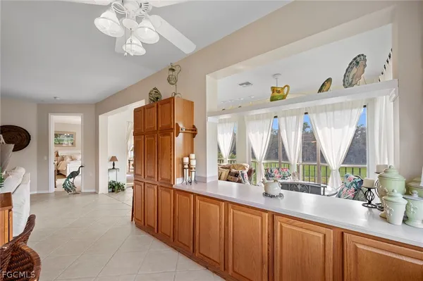 a kitchen with a sink and chairs