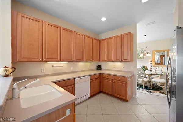 a kitchen with a sink window and cabinets