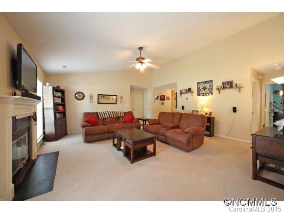 55 English Oak Road Fletcher, NC 28732 - Photo 2 of 17 a living room with furniture a fireplace and a flat screen tv
