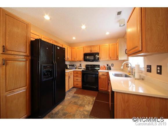 55 English Oak Road Fletcher, NC 28732 - Photo 4 of 17 a kitchen with a refrigerator a sink and a stove