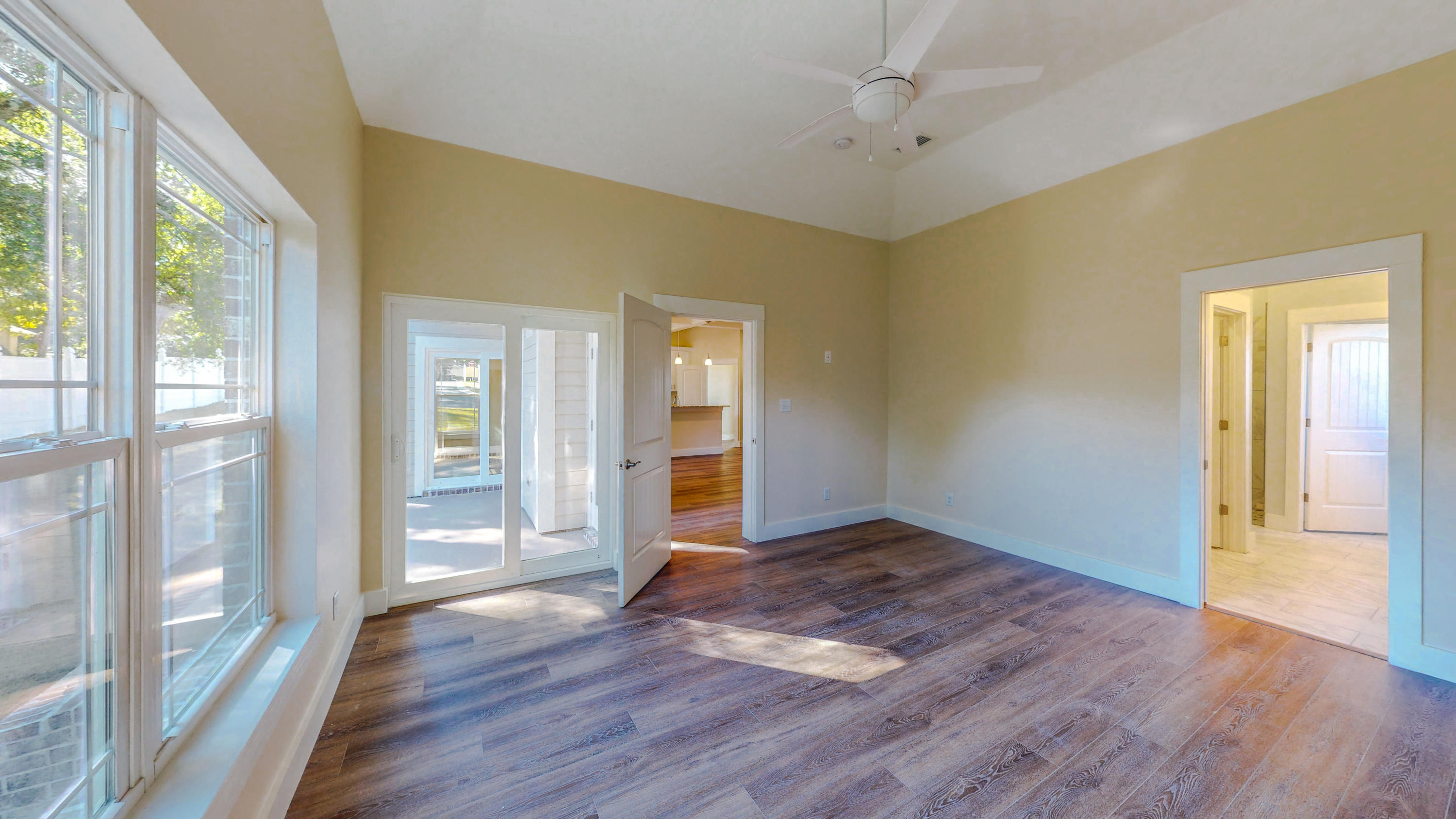 512 Harborview Circle Niceville, FL 32578 - Photo 18 of 42 an empty room with wooden floor and windows