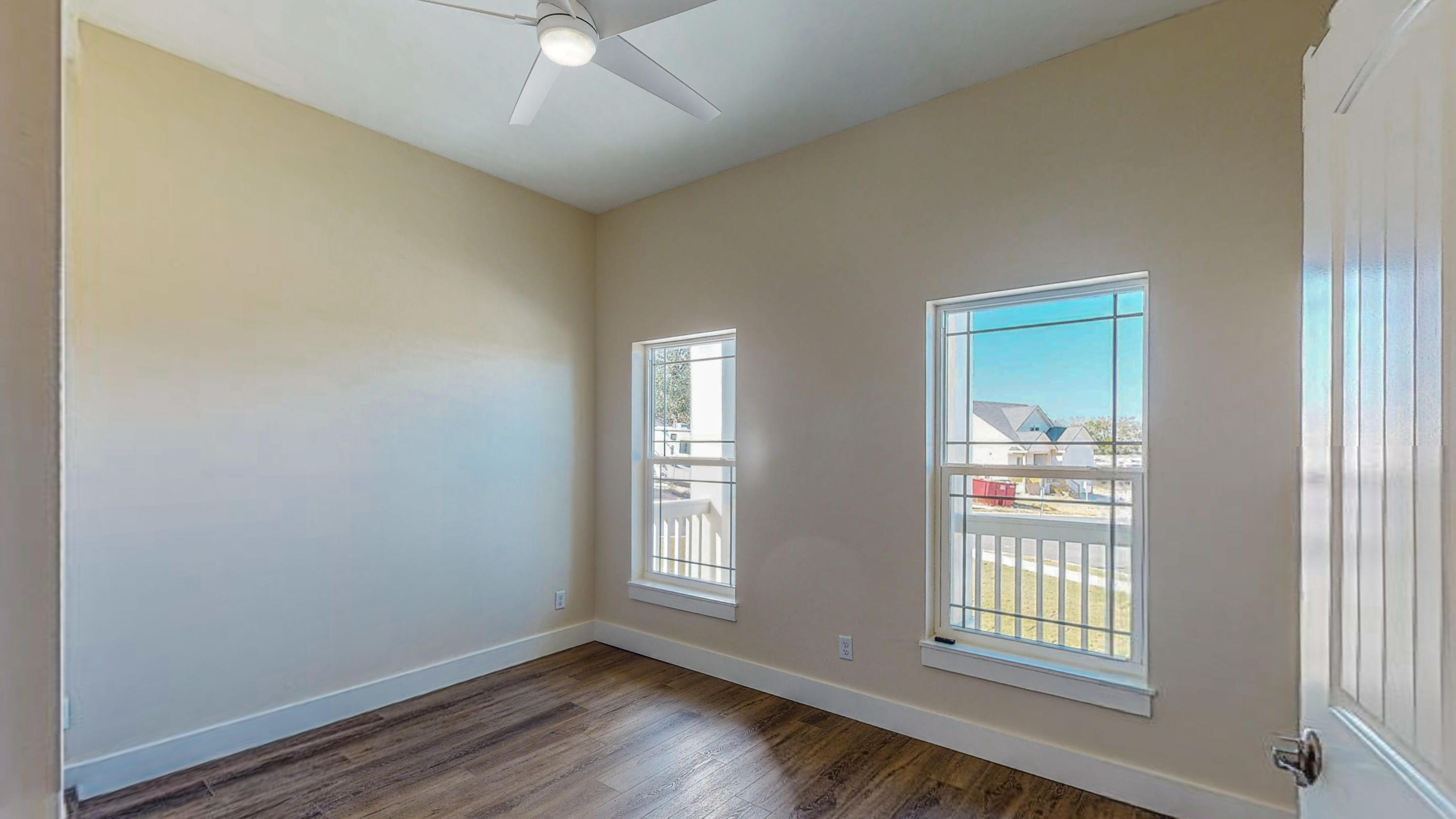 512 Harborview Circle Niceville, FL 32578 - Photo 25 of 42 an empty room with wooden floor and windows