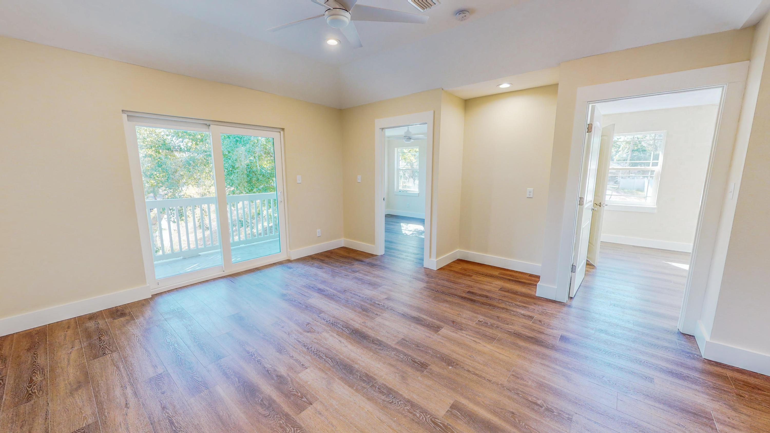 512 Harborview Circle Niceville, FL 32578 - Photo 28 of 42 an empty room with wooden floor and windows