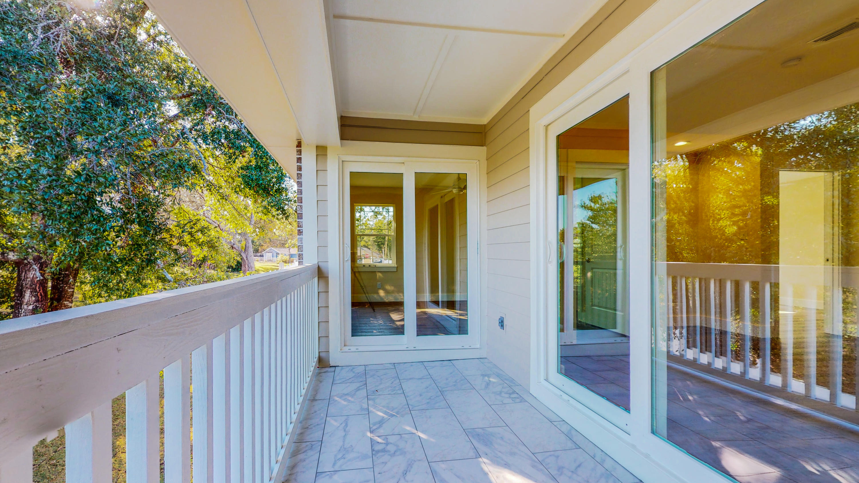 512 Harborview Circle Niceville, FL 32578 - Photo 29 of 42 a view of a porch with wooden floor and front door