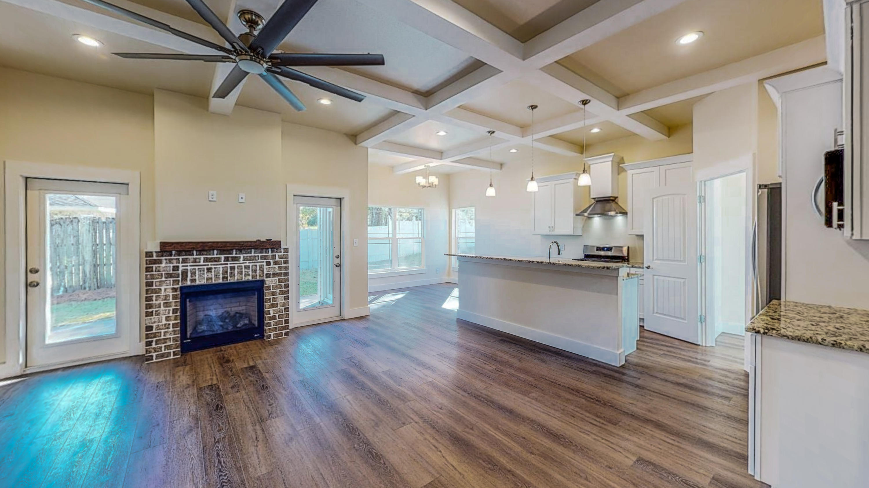 512 Harborview Circle Niceville, FL 32578 - Photo 7 of 42 a view of kitchen living room with wooden floor and fireplace