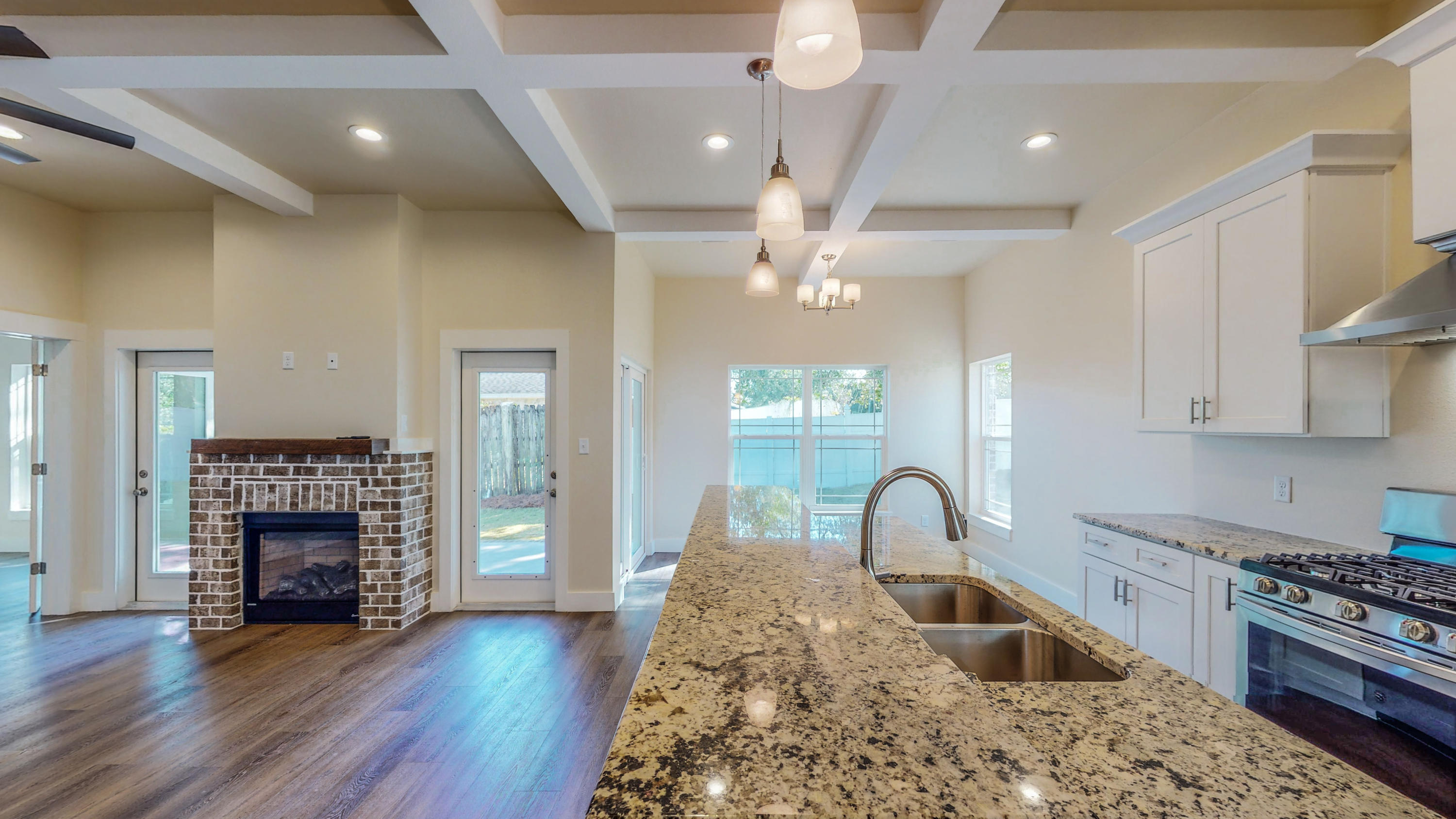 512 Harborview Circle Niceville, FL 32578 - Photo 8 of 42 a kitchen with kitchen island stainless steel appliances granite countertop a stove top oven a sink and a wooden floors