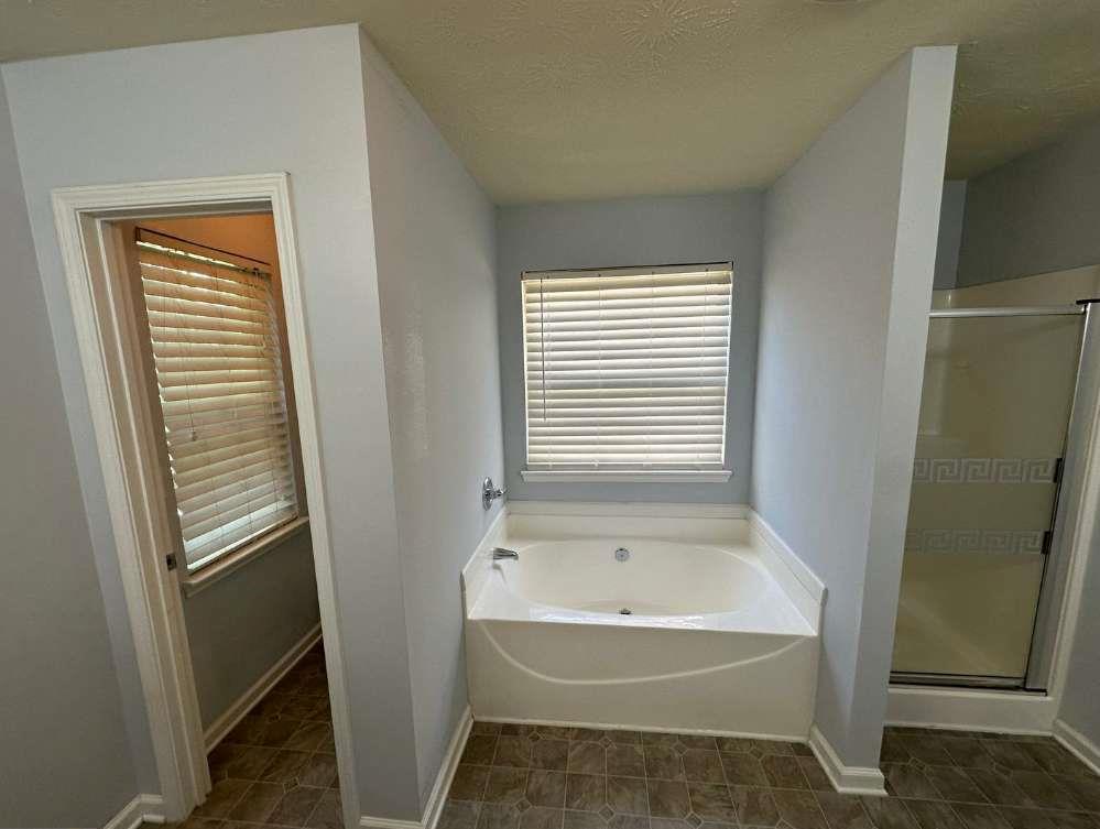 5103 Jack Drive Decatur, GA 30035 - Photo 15 of 34 a bathroom with a bathtub and a shower