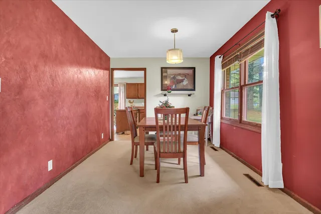 a view of a dining room with furniture window and outside view