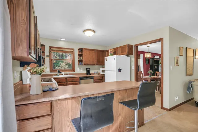 a kitchen with granite countertop stainless steel appliances a stove sink and microwave