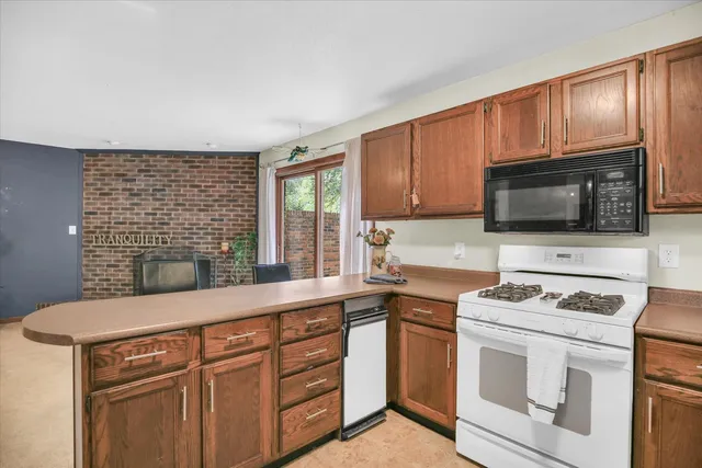 a kitchen with a sink stove and microwave