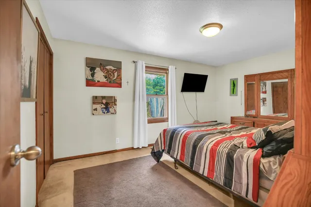 a bed sitting in a bedroom next to a window