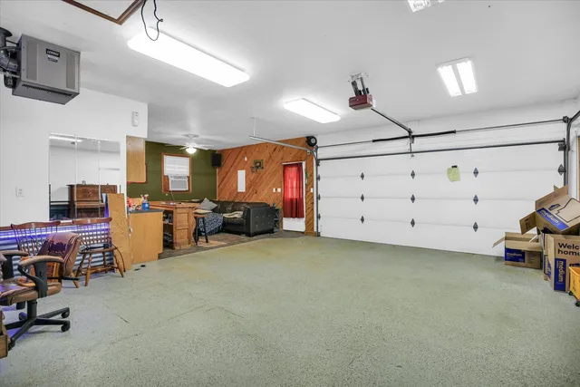 a living room with granite countertop furniture and a kitchen area