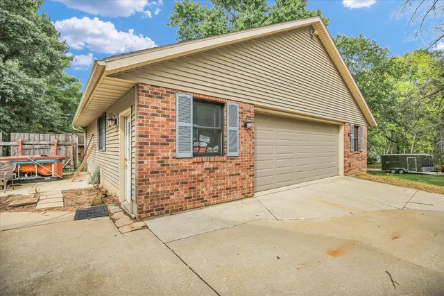 a view of a patio with table and chairs near a yard