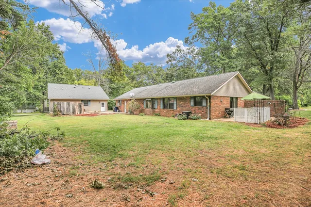 a view of a patio with table and chairs with wooden fence and floor
