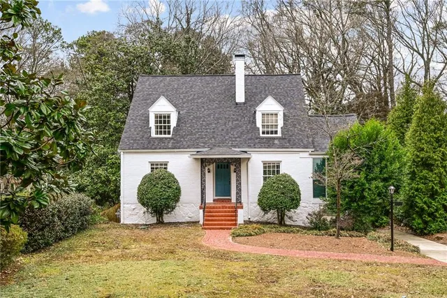 a front view of a house with a garden