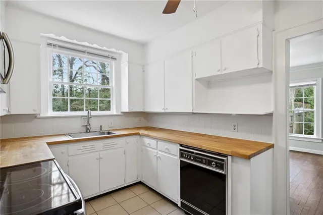 a kitchen with a sink stove and cabinets