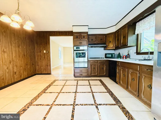a kitchen with stainless steel appliances granite countertop a sink and cabinets