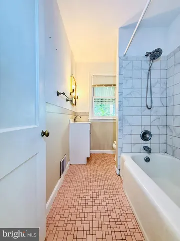 a bathroom with a bathtub and shower
