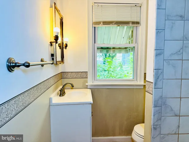 a bathroom with a sink a toilet and tub