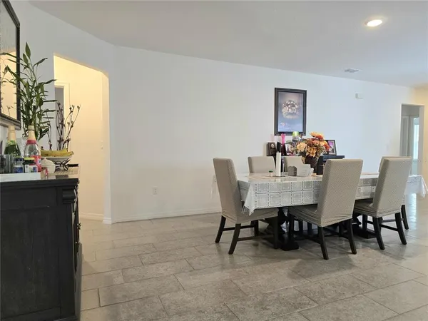 a view of a dining room with furniture and chandelier