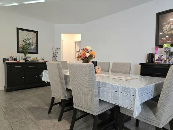 a dining room with furniture and window