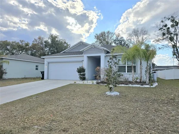a view of a house with a yard and garage