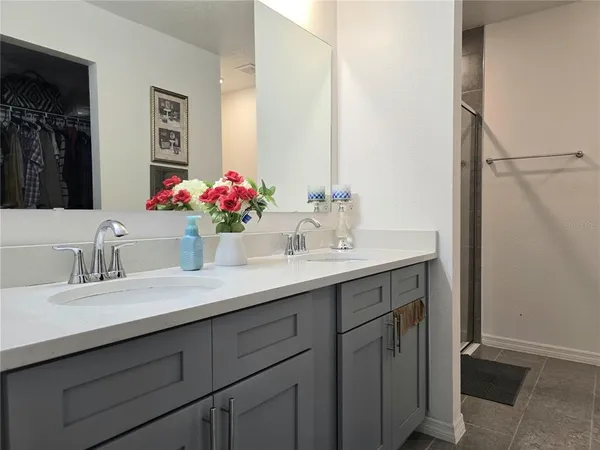 a bathroom with a sink vanity and a mirror